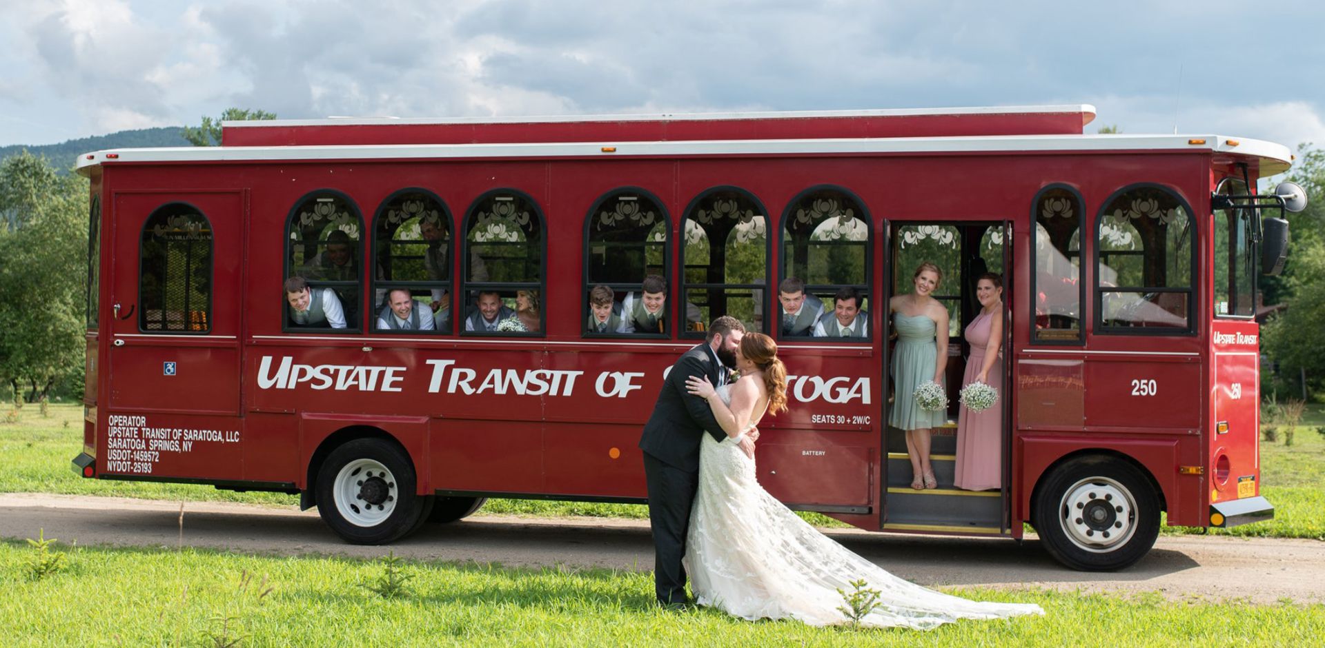 bride and groom kissing outside of trolley